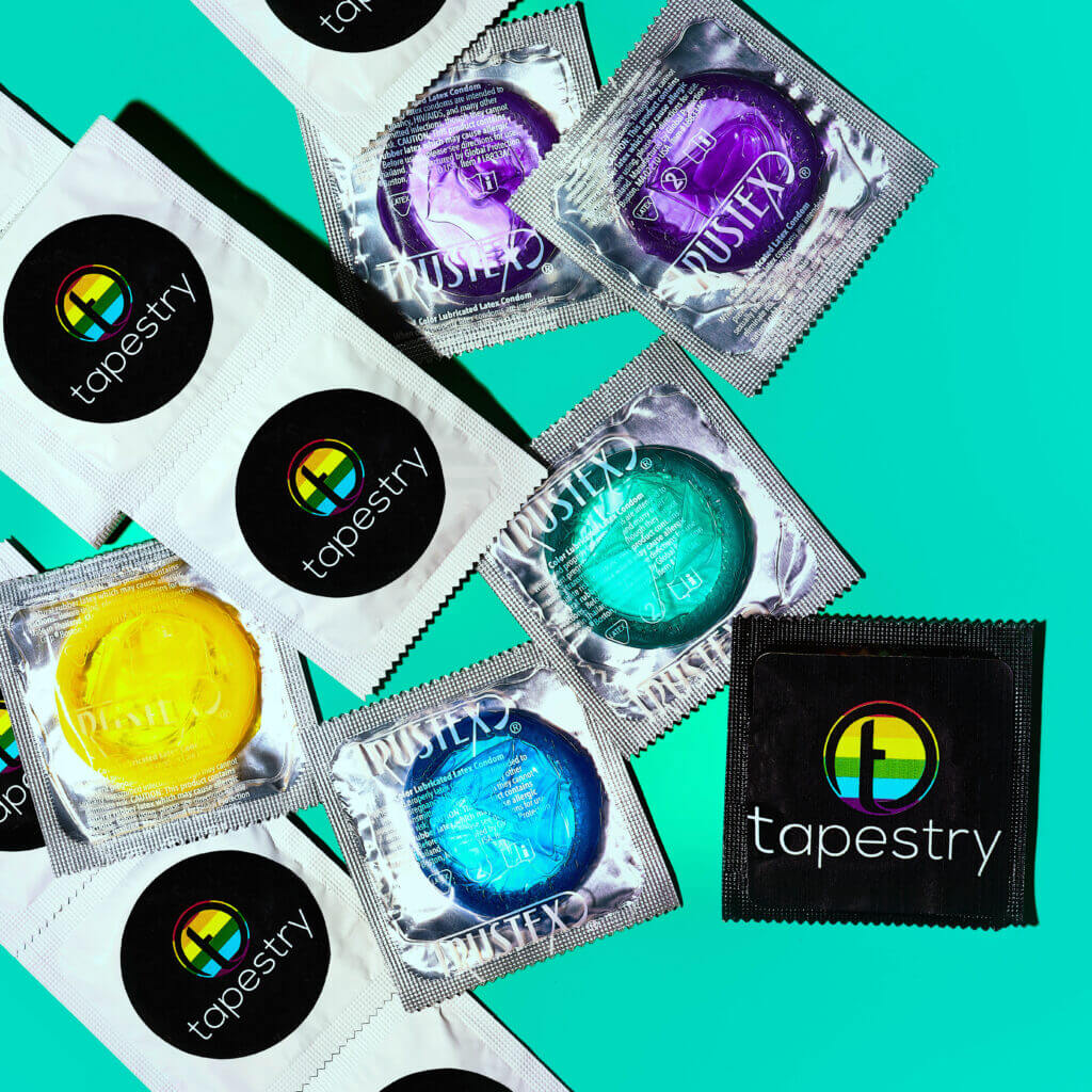 tapestry labeled condoms laid on a teal background